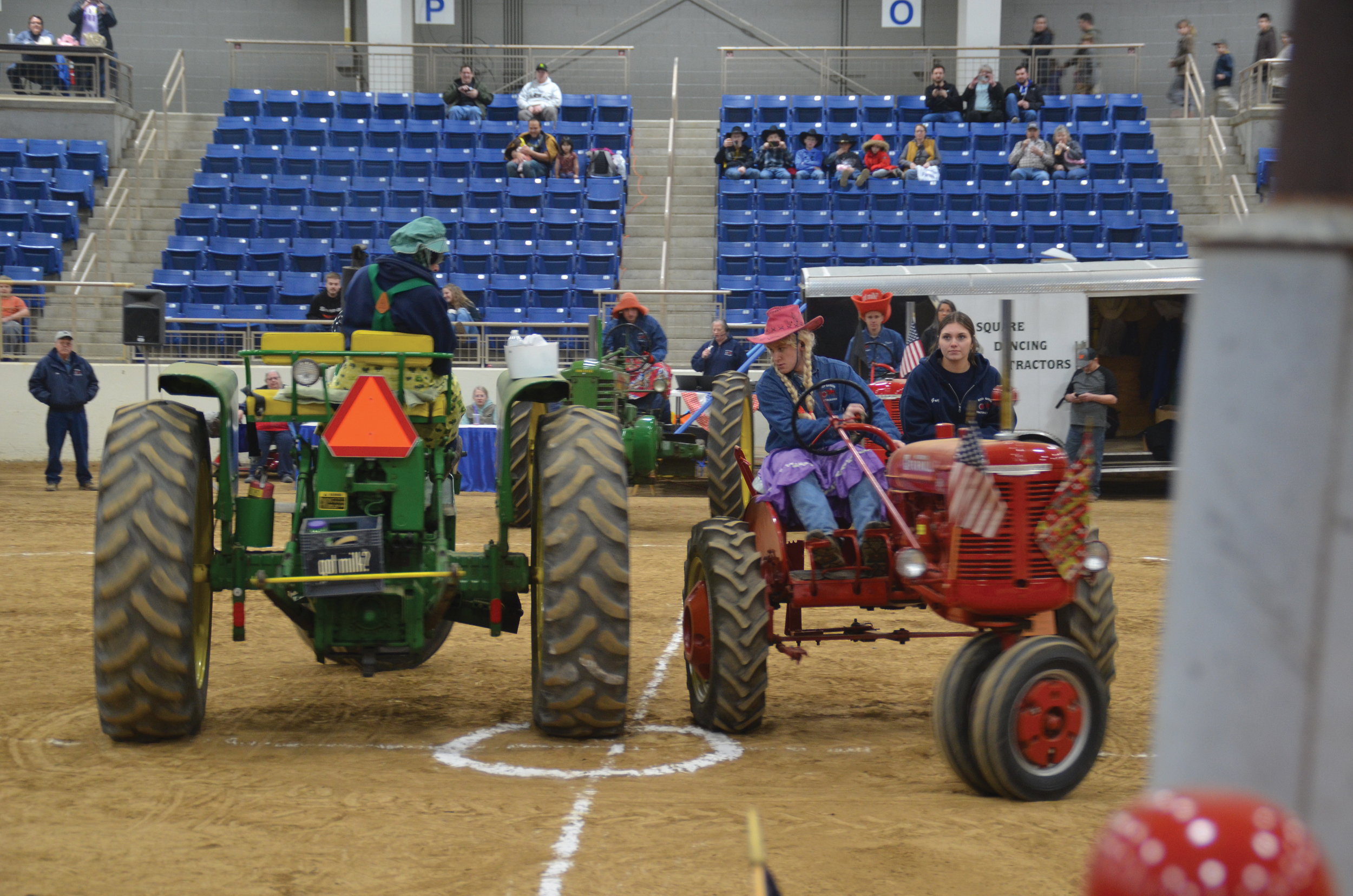 ill Blough, left, a founding member of Roof Garden Tractor Buddies in Somerset County, and Tyler Zimmerman perform a “right-hand star” during the tractor square dance at the 2023 Pennsylvania Farm Show. Also shown, at right, is Lauren Baker, riding in the buddy seat.