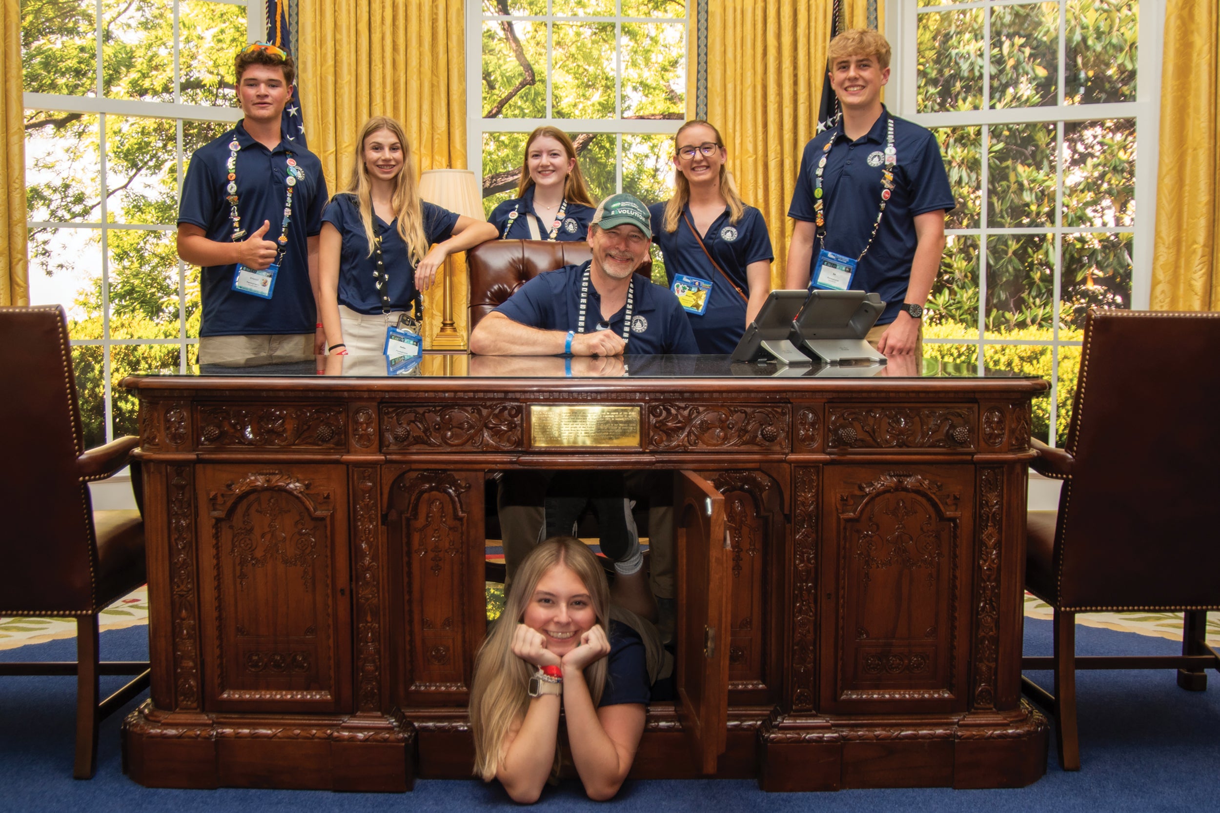 While visiting The People’s House: A White House Experience, Amanda Allabaugh of Claverack Rural Electric Cooperative (REC), front, finds a hidden compartment in the resolute desk. Other Claverack REC representatives, from left, are: Everett Leonard, Bella Clark, Maia Montross, chaperones Steve Allabaugh, the co-op’s president and CEO, and Megan Rought, and student Ed Eastman.