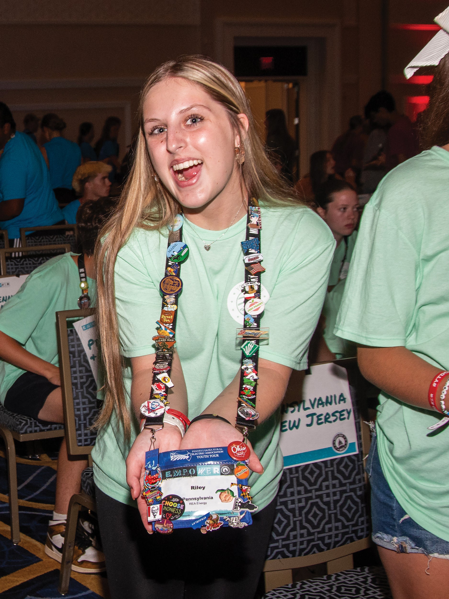 Riley McCausland of REA Energy Cooperative, based in Indiana, Pa., shows off her collection of state pins.
