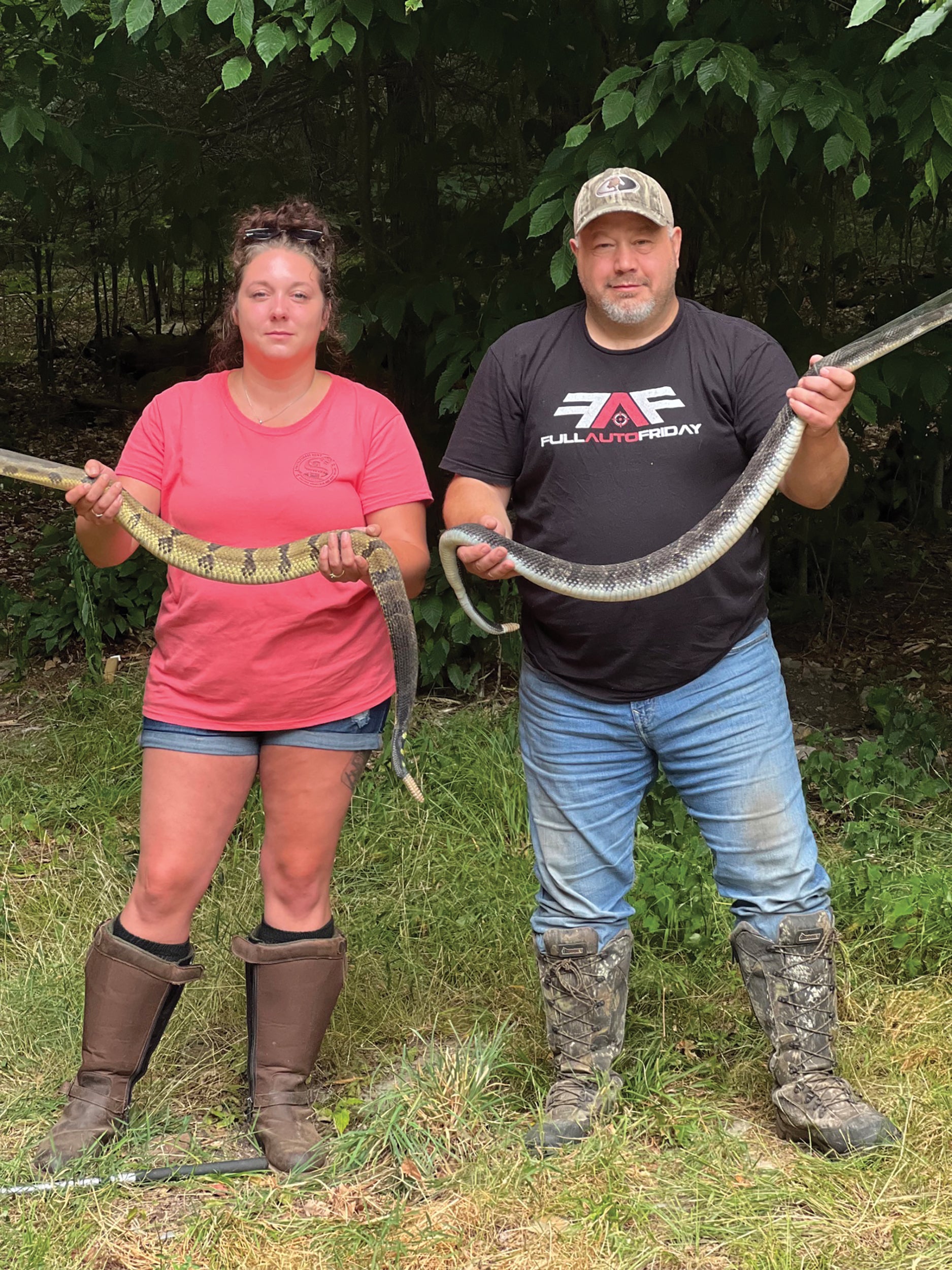 Rattlesnake hunters Jessica and Wade Graham hold the prize-winners that earned them the top spot in a 2022 teams contest.