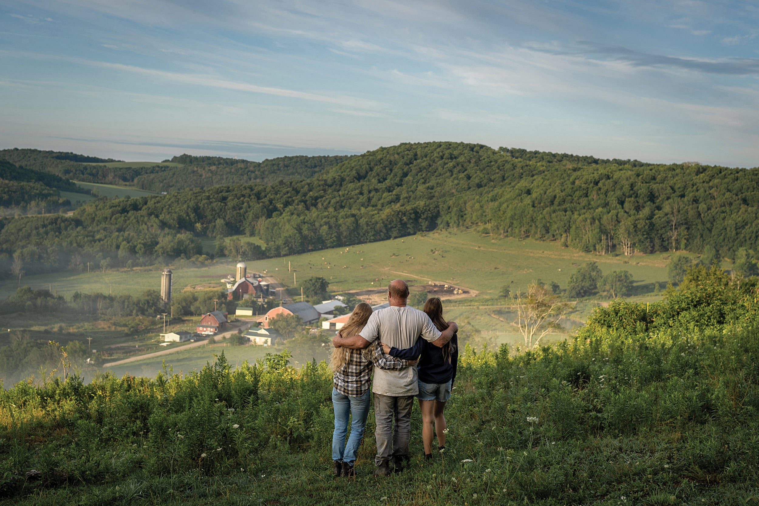 The Painters — Stephanie, Hayley and their dad, Clinton — overlook their 5,000-acre Tioga County dairy farm