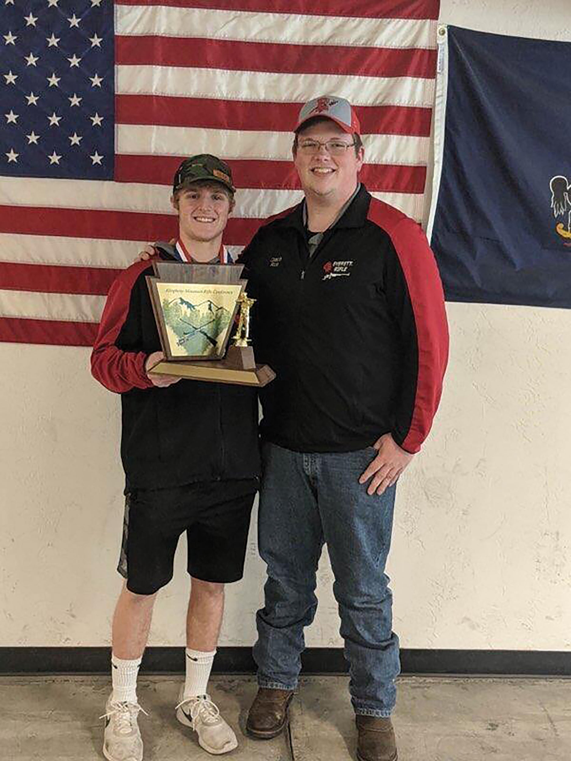Coltin Rice, right, head coach of the undefeated Everett High School Rifle Team, congratulates one of his students, Jesse Chamberlain, for his performance at the 2020 Allegheny Mountain Rifle Conference.