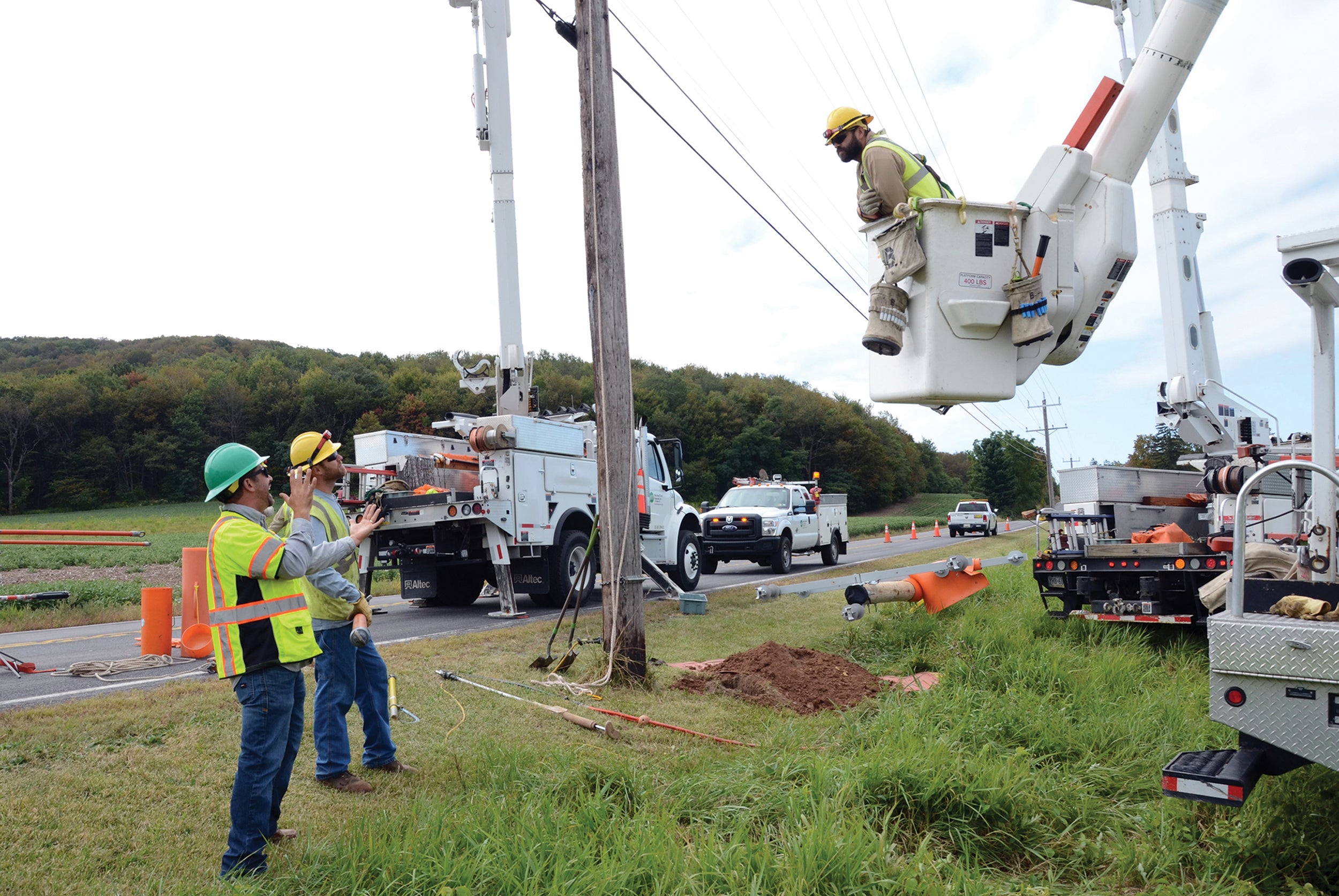 Fred Kuzemchak, left, a safety instructor with the Pennsylvania Rural Electric Association, provides on-the-job training at Huntingdon-based Valley Rural Electric Cooperative. He is shown with, from left, linemen Curt Wilson and Matt Fish.