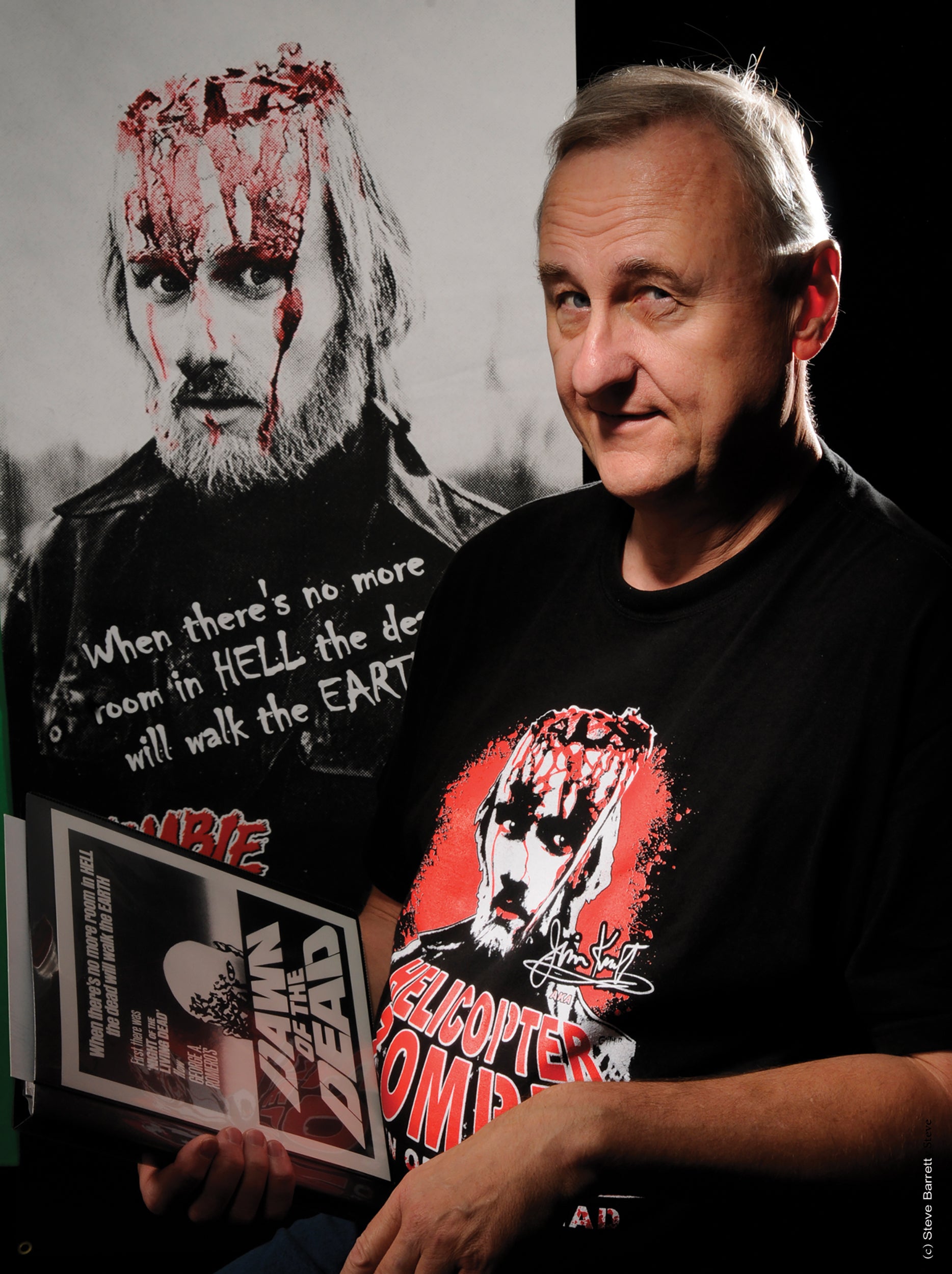 Jim Krut next to a poster of him as the helicopter zombie