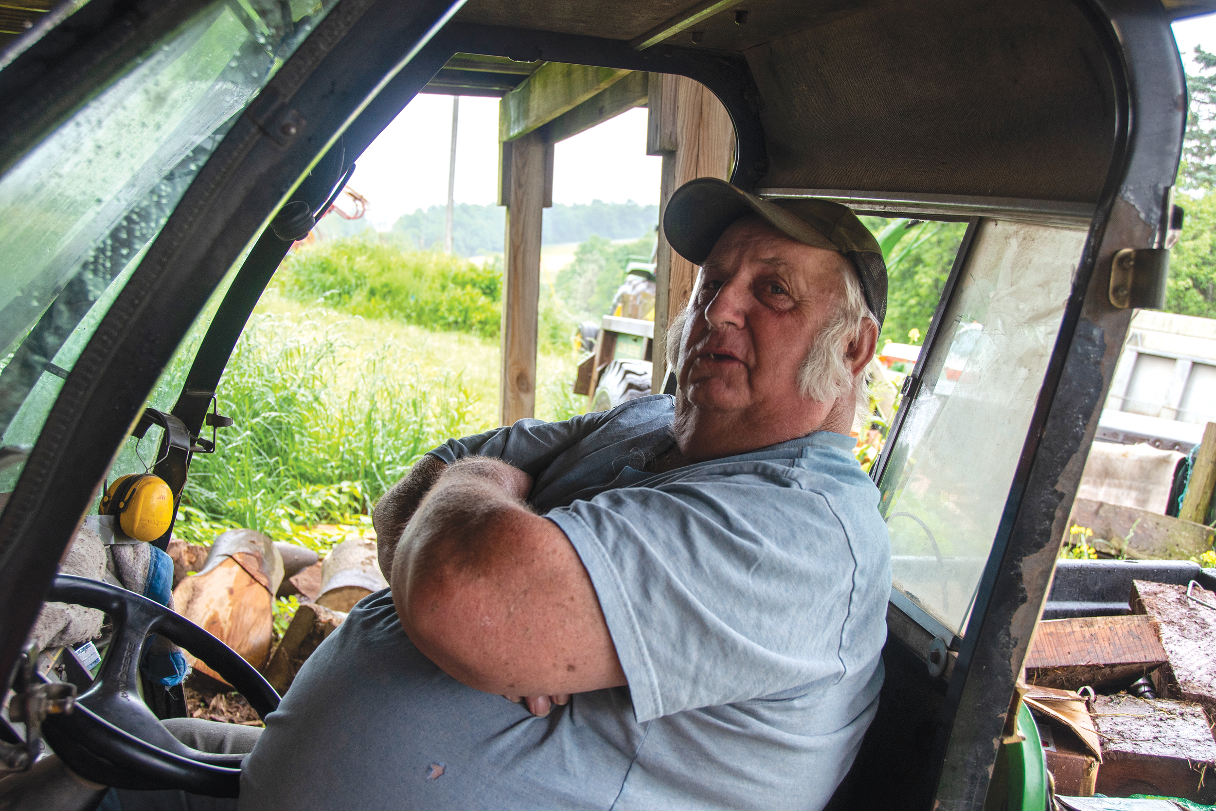A MEANINGFUL TOOL: Richard Coughenour, former owner of Little Piney Farm in Salisbury and member of Somerset Rural Electric Cooperative, sits in a utility all-terrain vehicle he uses to move around his farm and avoid putting undue strain on his back and knees.