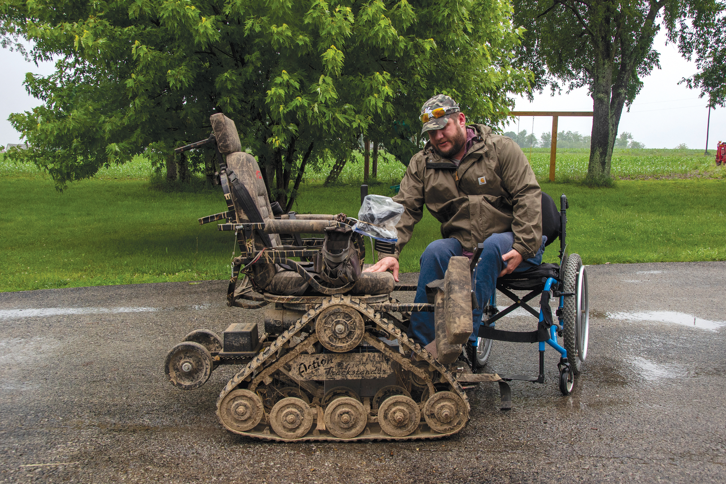 Ryan Frye, co-owner of RDR Farms in Blairsville and a member of Indiana-based REA Energy Cooperative, begins to lift himself out of his manual wheelchair into a mechanized, all-terrain wheelchair.