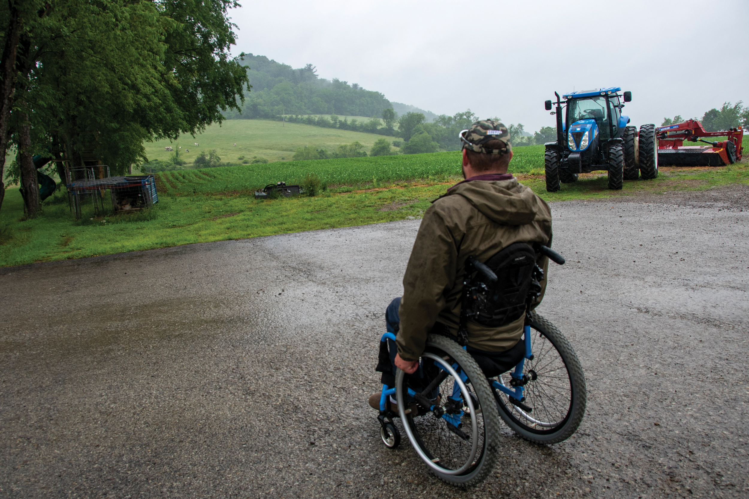NEVER QUIT: Ryan Frye, who was paralyzed from the waist down at 19 after an ATV accident and spinal hematoma, wheels himself across the driveway adjacent to his corn field.