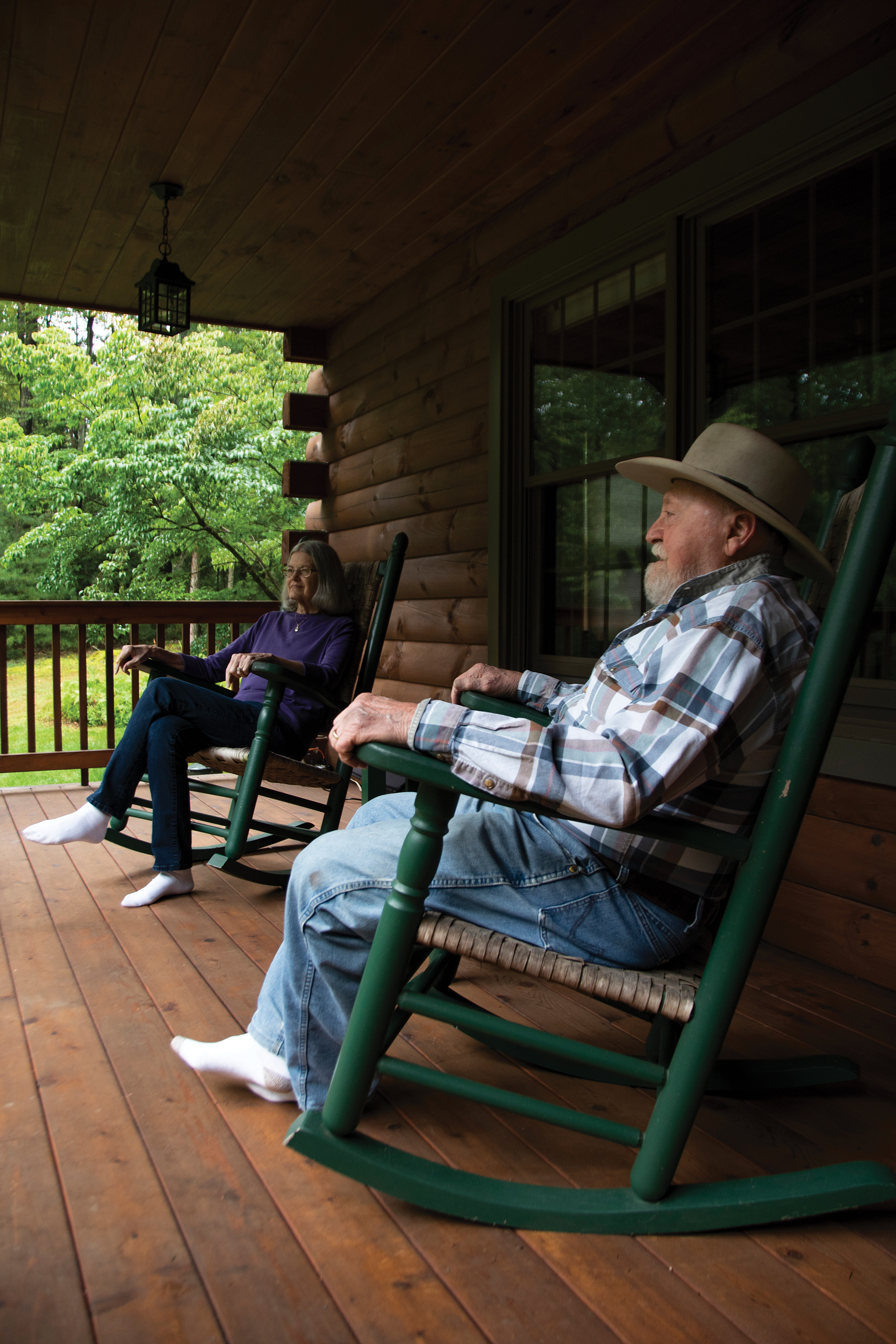 Ray and Debbie Slothour, members and former employees of Gettysburg-based Adams EC, enjoy the front porch of their log home in Orrtanna.